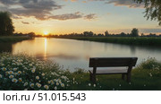 Breathtaking sunset illuminates a calm riverbank, where a bench invites quiet reflection among vibrant wildflowers and lush greenery. Стоковое AI-видео, аниматор Данила Большаков / Фотобанк Лори
