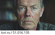 An older man with a serious expression contemplates his life experiences while seated indoors, surrounded by warm, natural light. Стоковое AI-видео, аниматор Данила Большаков / Фотобанк Лори