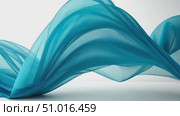 Delicate blue fabric flows and swirls elegantly, showcasing its texture and movement in a creative arrangement. Стоковое AI-видео, аниматор Данила Большаков / Фотобанк Лори