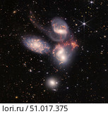 Combined NIRCam and MIRI image of Stephan's Quintet, captured by the James Webb Space Telescope. Стоковое фото, фотограф Stocktrek Images, Inc. / ТАСС / Фотобанк Лори
