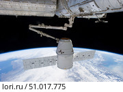 SpaceX Dragon during its docking with the International Space Station. Стоковое фото, фотограф Stocktrek Images, Inc. / ТАСС / Фотобанк Лори