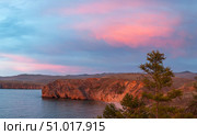 Beautiful bright sunset sky with pink clouds over Baikal Lake coast after rain. View of Small Sea and the steppes of Olkhon Island. Scenic landscape. Natural background. Summer travel and recreation. Стоковое фото, фотограф Виктория Катьянова / Фотобанк Лори