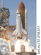 Space shuttle Atlantis' twin solid rocket boosters ignite to propel the spacecraft off Kennedy Space Center's Launch Pad 39A. Стоковое фото, фотограф Stocktrek Images, Inc. / ТАСС / Фотобанк Лори