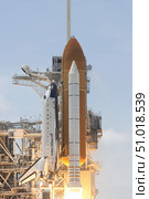 Space shuttle Atlantis' twin solid rocket boosters and three main engines ignite to propel the spacecraft off Kennedy Space Center's Launch Pad 39A. Стоковое фото, фотограф Stocktrek Images, Inc. / ТАСС / Фотобанк Лори