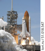 Atlantis' twin solid rocket boosters ignite to propel the spacecraft into orbit at Kennedy's Space Center. Стоковое фото, фотограф Stocktrek Images, Inc. / ТАСС / Фотобанк Лори