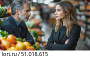 A man and woman discuss various topics while browsing through fresh produce at a busy grocery market during the afternoon. Стоковое AI-видео, аниматор Данила Большаков / Фотобанк Лори
