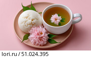 Enjoying a delicate Japanese dessert with warabi mochi and green tea. Стоковое AI-изображение, AI-художник Katsiaryna Repich / Фотобанк Лори