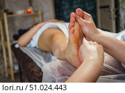 Natural medicine, reflexology, woman receiving foot massage, oppresses energy flow points, spa center calm interior. Стоковое фото, фотограф Владислав Тригуб / Фотобанк Лори