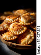 Delicious homemade empanadas filling a woven basket, freshly baked and ready to eat. Стоковое AI-изображение, AI-художник Юрий Поздников / Фотобанк Лори