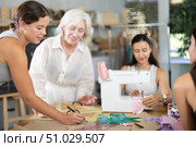 Young woman teacher explains to group how to draw pattern. Стоковое фото, фотограф Яков Филимонов / Фотобанк Лори