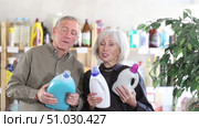 Senior spouses select and studies label liquid detergent. Стоковое видео, видеограф Яков Филимонов / Фотобанк Лори
