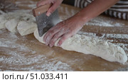 Female baker cutting dough into pieces with scraper close-up. Стоковое видео, видеограф Яков Филимонов / Фотобанк Лори