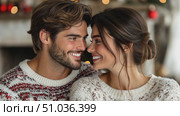 A young couple enjoys each other's company while wearing warm sweaters, surrounded by a festive atmosphere filled with holiday cheer. Стоковое AI-видео, аниматор Данила Большаков / Фотобанк Лори