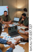 Collaborative Analysis Session with Team in Modern Office Setting, Discussing Data Insights and Strategies Shared on Laptops and Documents. Стоковое AI-видео, аниматор Владимир Федоров / Фотобанк Лори