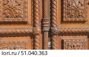 Ornate wooden door close-up with intricate carvings and decorative patterns, suitable for background. Стоковое видео, видеограф Анастасия Золотницкая / Фотобанк Лори