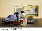 Men's watches in the foreground. In the background is a tie, perfume and cufflinks. A favorite focus, a place for text. A set of accessories for a wedding. Стоковое фото, фотограф Наталия Кирсанова / Фотобанк Лори