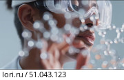Young scientist studying molecular structures in a laboratory setting focused on innovative research in chemistry. Стоковое AI-видео, аниматор Сергей Толмачёв / Фотобанк Лори