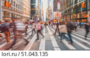 A blurred image capturing pedestrians crossing the street in a busy urban setting, showcasing movement and city life. Стоковое AI-видео, аниматор Данила Большаков / Фотобанк Лори