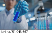 Scientist conducts experiments in laboratory with colorful liquids in test tubes showcasing chemical reactions. Стоковое AI-видео, аниматор Сергей Толмачёв / Фотобанк Лори