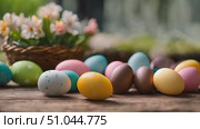 Collection of vibrantly dyed Easter eggs arranged neatly in front of a woven basket filled with delicate flowers. Стоковое AI-видео, аниматор Данила Большаков / Фотобанк Лори