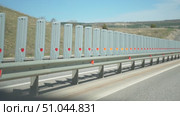 Highway Safety Barriers Roadside Protection - A row of highway safety barriers with reflective strips on a roadside in a sunny day. Стоковое видео, видеограф svetograph / Фотобанк Лори