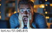 A man reacts in shock and disbelief while staring at his computer late at night, showcasing an intense emotional moment. Стоковое AI-видео, аниматор Данила Большаков / Фотобанк Лори