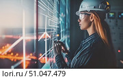 Engineer woman wearing a hard hat attentively examines something on a board, focusing intently on the task at hand. Стоковое AI-видео, аниматор Данила Большаков / Фотобанк Лори