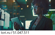 African American woman wearing glasses is focused on the computer screen, scrolling and typing. She appears engrossed in her work or activity. Стоковое AI-видео, аниматор Данила Большаков / Фотобанк Лори
