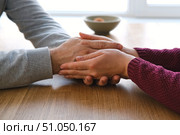 Couple holding hands at home. Happy Man and Woman. Two Loving Hands Together on the Couch Sharing Deep Affection and Love in Details. Intimate connection. Close-up of Intertwined female and male hands. Стоковое фото, фотограф Марина Демидюк / Фотобанк Лори