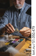 Senior fly tier crafting artificial fishing lures. Стоковое AI-видео, аниматор Юрий Поздников / Фотобанк Лори