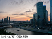 Moscow, Russia - July 18, 2025: Evening view of the Moscow International Business Center and surrounding high-rise developments, with the Moscow River. Редакционное фото, фотограф Софья Соломонова / Фотобанк Лори