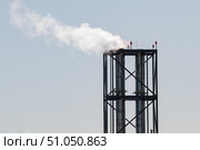 Две хромированные трубы котельной, из одной идёт пар. Трубы заключены в металлический каркас-параллелепипед. Фон — серо-голубое небо. Индустриальный стиль, технологии, Стоковое фото, фотограф Алексей Винников / Фотобанк Лори