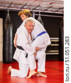 Senior aikido practitioner training with partner in dojo. Стоковое фото, фотограф Яков Филимонов / Фотобанк Лори