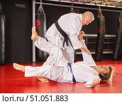 Karate with male athletes practicing, training and sparring in fight class. Стоковое фото, фотограф Яков Филимонов / Фотобанк Лори