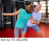 Male pupil clash with training manager during self-defense lesson, repulse charge, intensity of practice. Стоковое фото, фотограф Яков Филимонов / Фотобанк Лори