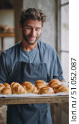 Freshly baked croissants are presented by a skilled baker in a cozy bakery setting this morning. Стоковое AI-видео, аниматор Сергей Толмачёв / Фотобанк Лори