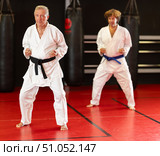 Sensei demonstrating kata with student on tatami. Стоковое фото, фотограф Яков Филимонов / Фотобанк Лори