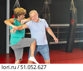 Senior man grimacing in pain during sparring in self-defense class. Стоковое фото, фотограф Яков Филимонов / Фотобанк Лори