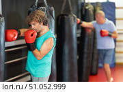 Man practicing strikes on punchbag in self‑defense class. Стоковое фото, фотограф Яков Филимонов / Фотобанк Лори