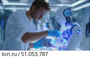Expert examines advanced humanoid robot in a futuristic lab focused on technology and innovation. Стоковое AI-видео, аниматор Сергей Толмачёв / Фотобанк Лори