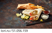 Eastern traditional shawarma and French fries with sauces on slate. Стоковое фото, фотограф Ирина Буракова / Фотобанк Лори