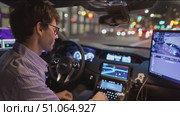 Engineer tests automated vehicle technology at night in urban environment while monitoring systems. Стоковое AI-видео, аниматор Сергей Толмачёв / Фотобанк Лори