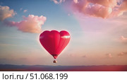 Enchanting sight of vibrant red heart-shaped balloon as it gracefully floats and dances amidst the clouds. Стоковое AI-видео, аниматор Данила Большаков / Фотобанк Лори