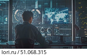 A skilled analyst observes complex data on multiple screens in a sophisticated control room after dusk. Стоковое AI-видео, аниматор Данила Большаков / Фотобанк Лори