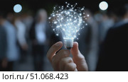Innovative light bulb representing creativity and ideas at a networking event in a busy urban area. Стоковое AI-видео, аниматор Сергей Толмачёв / Фотобанк Лори