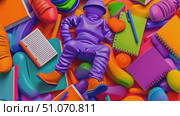 This video shows a purple figure laying among colorful school supplies, such as notebooks, pens, and shoes. Стоковое AI-видео, аниматор Данила Большаков / Фотобанк Лори