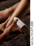 Waxing Technician Applying Wax to Client’s Leg Indoors at the Salon. Стоковое фото, фотограф Aleksandr Golubev / Фотобанк Лори