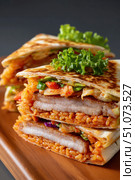Delicious quesadillas filled with kimchi fried rice and grilled pork belly resting on wooden board. Стоковое AI-изображение, AI-художник Юрий Поздников / Фотобанк Лори
