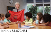 listening to teacher s story about Morocco, girl examines this country on globe. Стоковое видео, видеограф Яков Филимонов / Фотобанк Лори