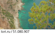 View of rocky coastline and emerald sea waters below steep cliffs in Capri Italy. Стоковое видео, видеограф Ольга Сухарева / Фотобанк Лори